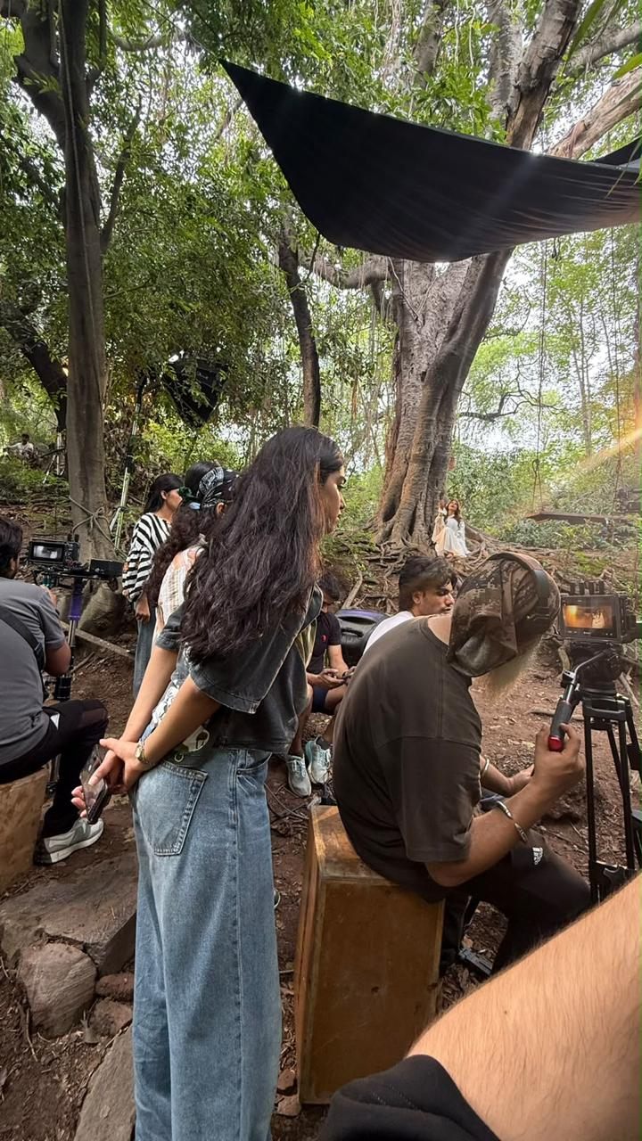 Crew setting up an outdoor shoot under the trees