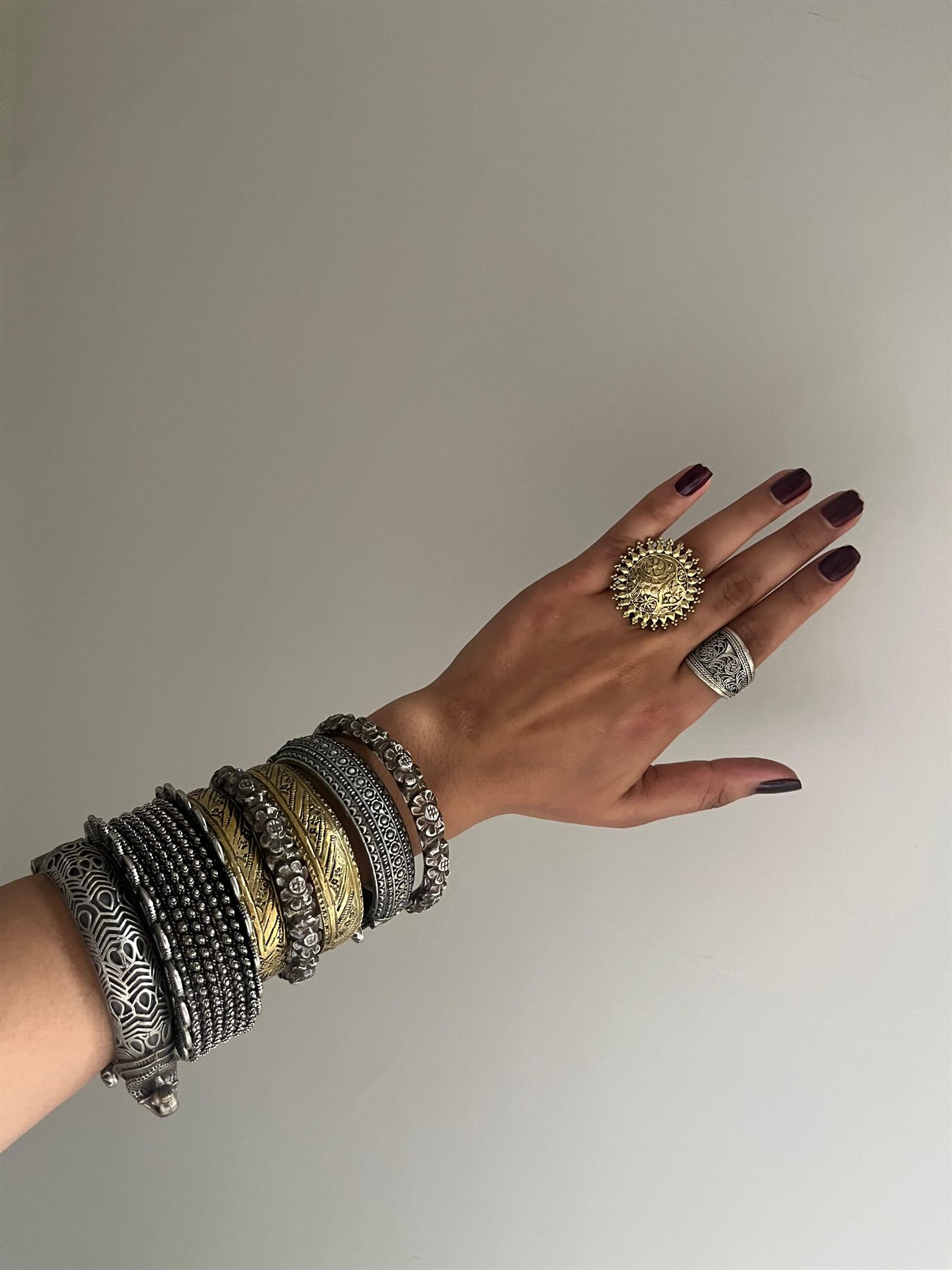 Stacked bangles and a statement ring styled for a shoot